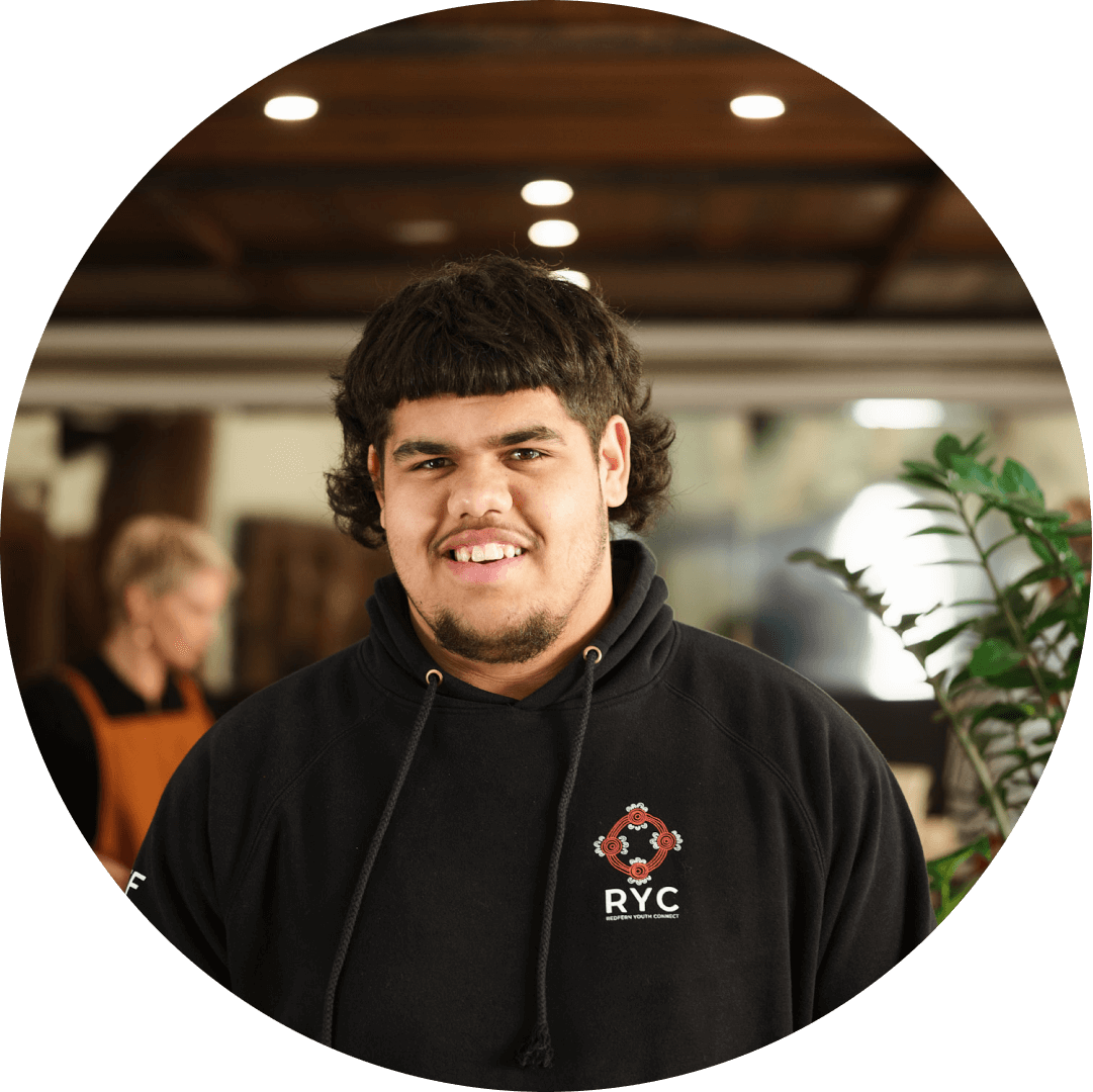 A representative of Redfern Youth Connect stands smiling in the Hope Hospitality Foundation's kitchen